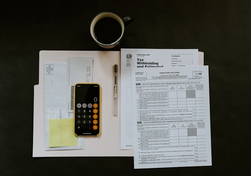 Tax forms and a calculator used to trace hidden assets in a Nevada divorce